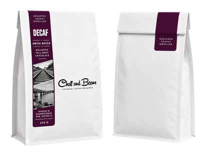 Front and back of a white Chaff and Beans coffee bag with a deep plum label reading Decaf, Swiss Water, balanced, full body, chocolate, 250 g.
